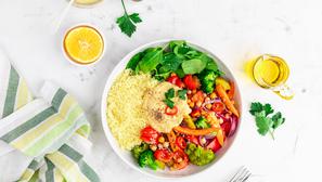 Baked vegetables with hummus bowl. Salad with baked potato, zucchini, broccoli and hummus.