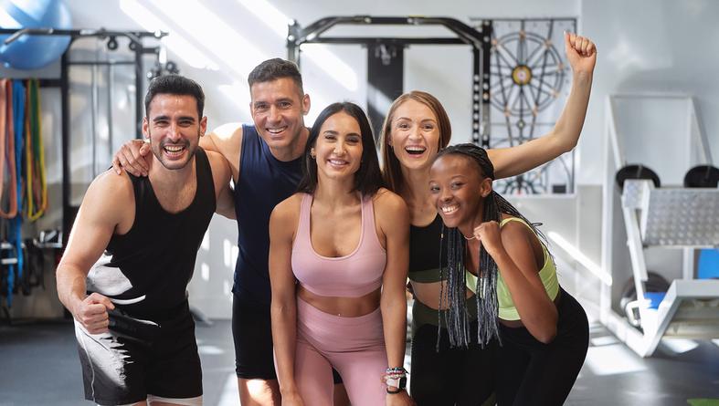 Multicultural,Fitness,Group,Posing,And,Smiling,Looking,At,The,Camera