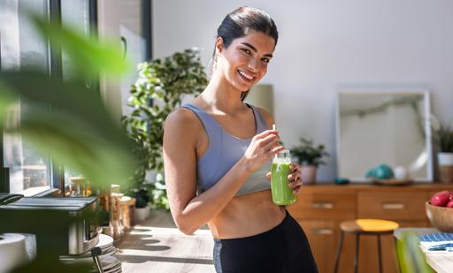 Shot,Of,Sporty,Young,Woman,Drinking,A,Vegetable,Green,Handmade
