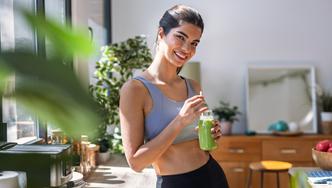 Shot,Of,Sporty,Young,Woman,Drinking,A,Vegetable,Green,Handmade